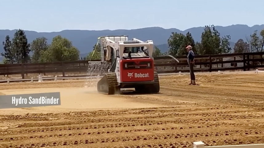 Hydro SandBinder being sprated in a sand arena outdoors