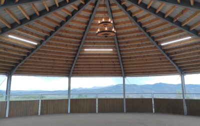 Looking from the inside of a covered round pen, out toward a mountain range