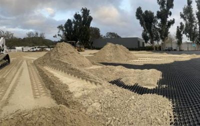Sand being installed in the outdoor arena in Malibu.