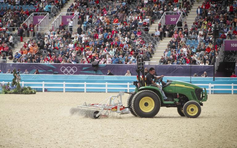 A Platz Max arena drag is being used to groom the jumping arena at the Olympics