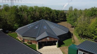 A fully covered, round horse walker, taken with a drone