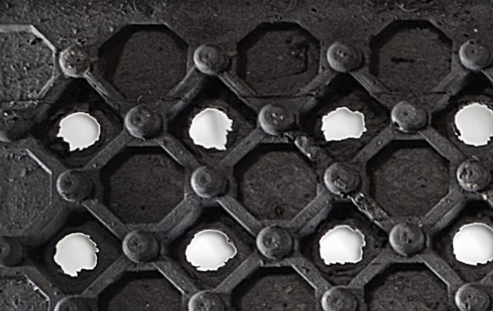 An arena mat with diamond pattern and drain holes