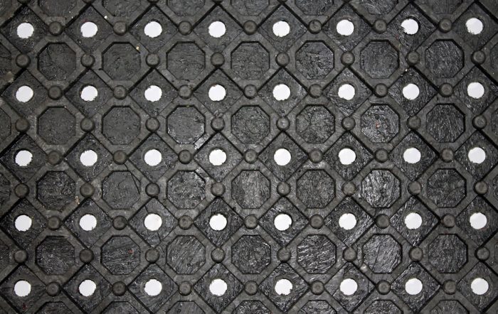 An arena mat with diamond pattern and perforations