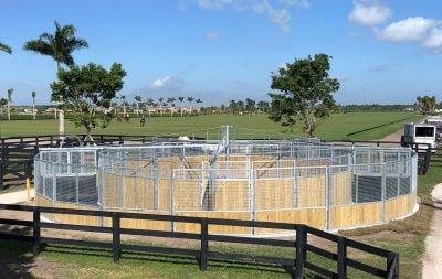 A round, uncovered horse walker from the side