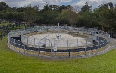 A round, uncovered horse walker from the side and above