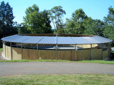 A round horse walker with the walking lane covered, and the interior uncovered