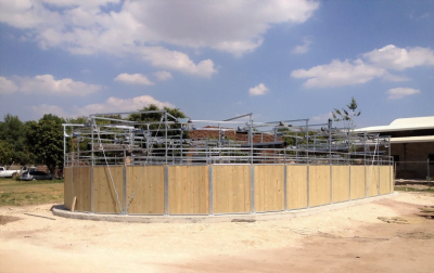 An oval horse walker without a roof, taken from an angle