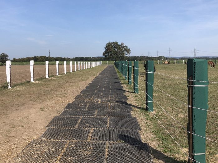 A row of paddock mats installed to reduce mud