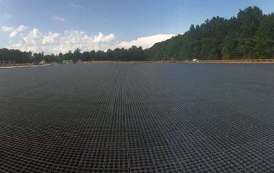 A wide angle photo of the over-sized Brave Horse outdoor arena, that is under construction with DrainGrids installed.