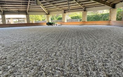 A nicely groomed covered arena.