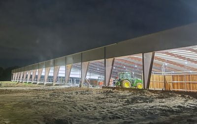 Sand being laid and spread at the covered arena in Pilot Point.