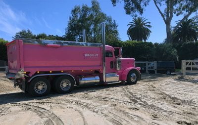 A pink construction truck brings sand to help build the outdoor arena at Hope Ranch