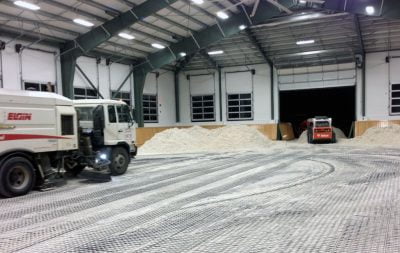 Heavy equipment begins to lay sand in the indoor arena in Langley, BC.