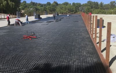 Workers lay HIT Draingrids as the base of the new dressage arena at Palos Verdes.