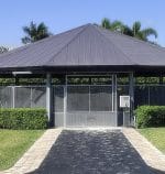 A walkway with pavers leads up to a covered round pen.