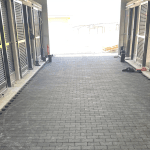 Black pavers installed in a barn aisle