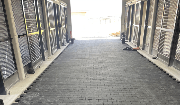 Black pavers installed in a barn aisle